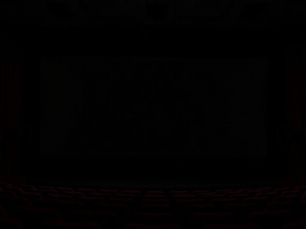 cinema screen fading to black with rolling credits and soft glowing light in a dark theater