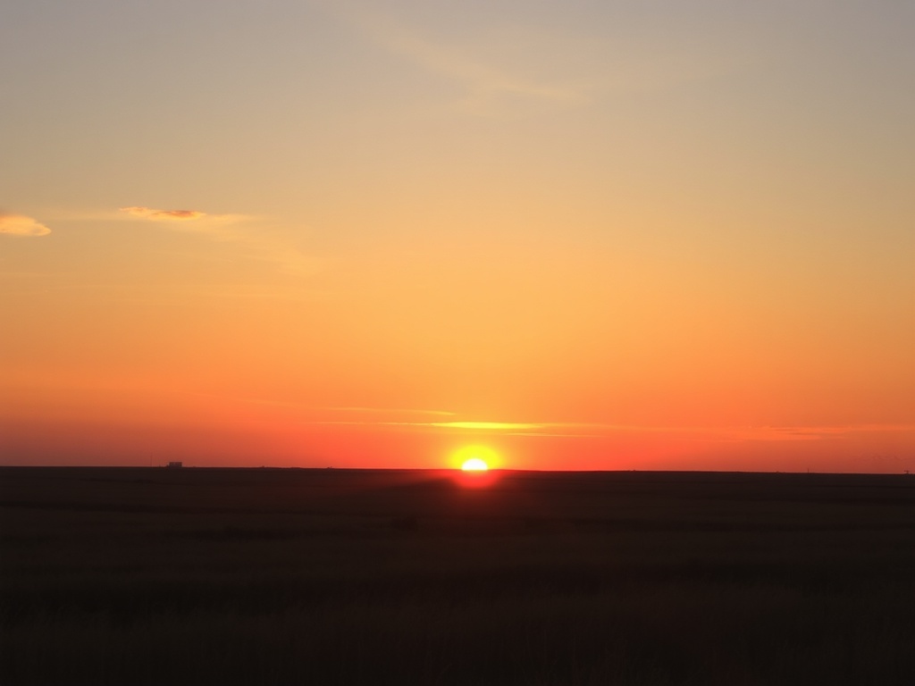 open prairie horizon at sunset, warm glow, sense of calm completion