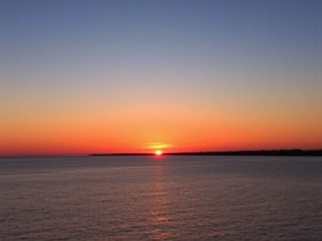 sunset over Bay of Quinte, orange sky reflection on water, calm evening atmosphere