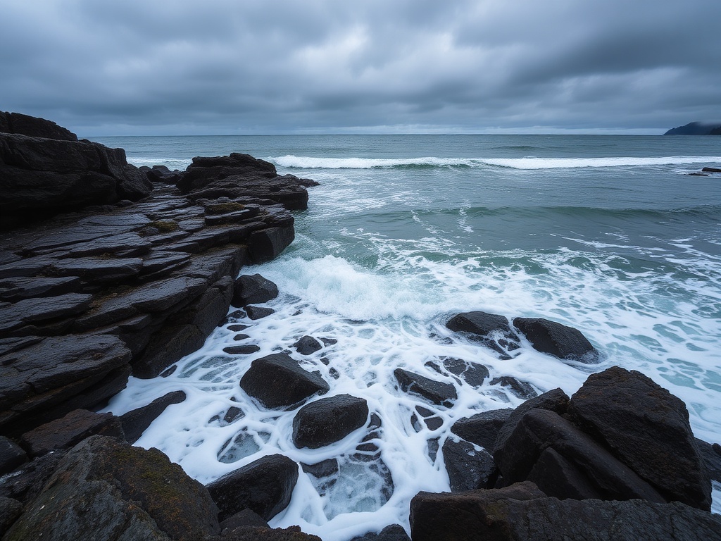 waves rolling into rocky shoreline in Ucluelet under overcast sky with dramatic texture